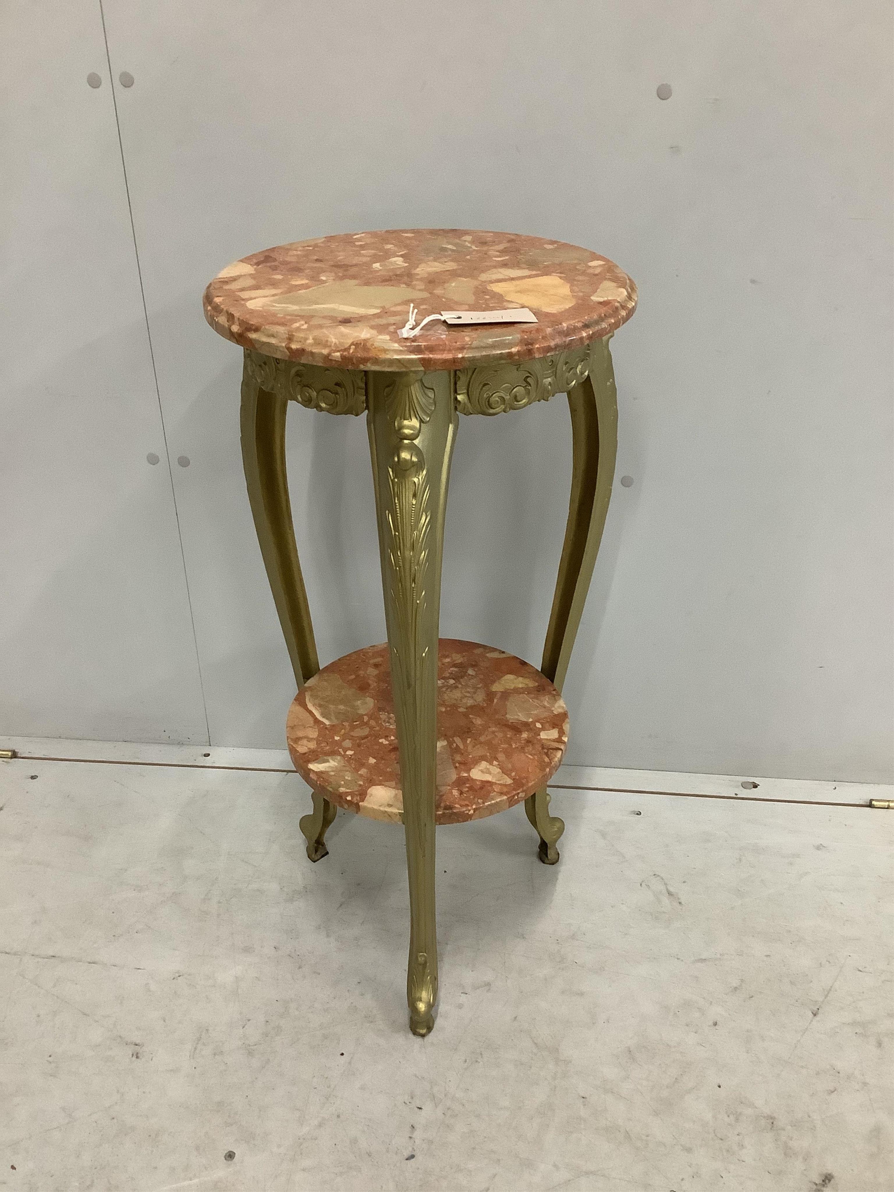 An early 20th century French circular reconstituted marble and cast metal two tier table, diameter 38cm, height 79cm. Condition - good